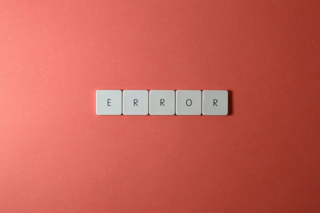 White letter tiles spelling 'ERROR' on a red backdrop, offering a minimalist design concept.